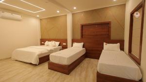 a room with two beds in a room at Bekal Gate Residency in Kotikulam