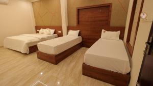 a room with two beds and a mirror at Bekal Gate Residency in Kotikulam