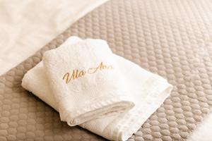 a white towel with the word aloemite on a bed at Vila Ana in Štanjel +32 photos