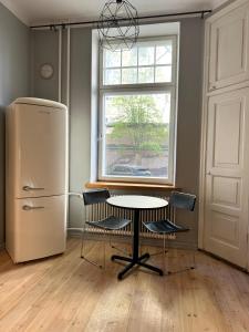 a kitchen with a table and chairs and a window at Downtown Townhouse! in Helsinki