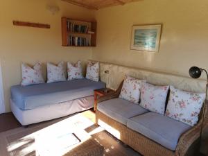 a living room with two couches and a couch at Bergplaas Nature Reserve in Nieu-Bethesda