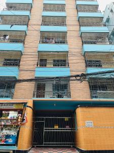 a tall building with many windows and bars at Tourist Home in Ābdullāpur
