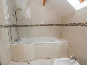 a bathroom with a bath tub and a sink at Willow Lodge in Knighton +30 photos