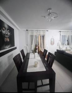 a dining table and chairs in a living room at Seafront Chalet Muchavista direct beach access in El Campello