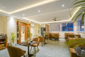a restaurant with tables and chairs and a dining room at Tripli Hotels Solune in Rishīkesh