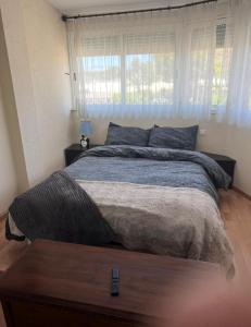 a bedroom with a large bed with blue pillows at Seafront Chalet Muchavista direct beach access in El Campello +47 photos