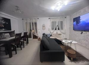 a living room with a couch and a dining room at Seafront Chalet Muchavista direct beach access in El Campello
