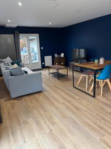 a living room with a couch and a table at La Petite Maison in Arsy