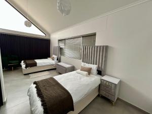 a bedroom with two beds and a window at EHH Accommodation Hentiesbay in Hentiesbaai