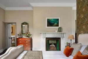 a bedroom with a bed and a fireplace at Dripsey Castle Estate in Dripsey +35 photos