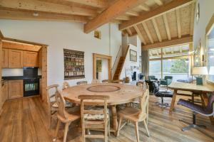 a kitchen and dining room with a wooden table and chairs at Chesa Pino - Madulain in Madulain