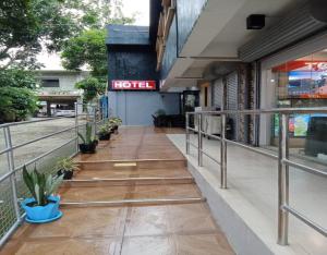 a building with a hotel sign on the side of it at Regina Hotel in Balasan