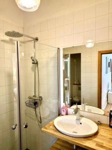a bathroom with a sink and a shower at Downtown Townhouse! in Helsinki