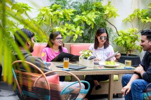 a group of people sitting at a table in a restaurant at The Park Bangalore, MG Road in Bangalore