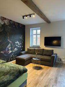 a living room with a couch and a flat screen tv at Hostel Farm Ostedt in Wrestedt