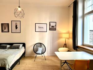 a bedroom with a bed and a table at Downtown Townhouse! in Helsinki