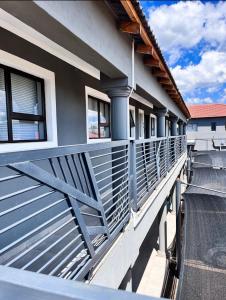 a balcony of a house with blue metal railing at Cubes Ledig Luxury Apartments in Ledig
