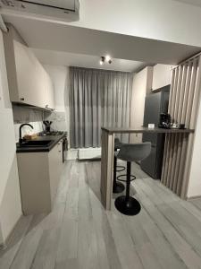 a kitchen with a table and a chair in a room at The Urban Line by D'or Selection in Bucharest