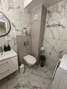 a bathroom with a toilet and a sink at The Urban Line by D'or Selection in Bucharest