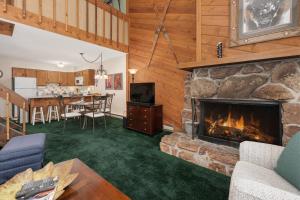 a living room with a fireplace and a dining room at Sun Song 3F in Fraser