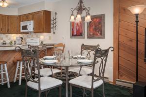 a dining room and kitchen with a table and chairs at Sun Song 3F in Fraser