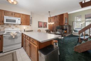 a kitchen with wooden cabinets and a counter top at Sun Song 3F in Fraser +17 photos