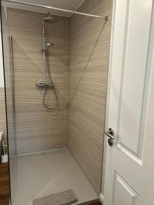a shower in a bathroom with a glass door at Hostel Farm Ostedt in Wrestedt +25 photos