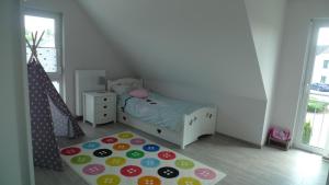 a small bedroom with a bed and a rug at Ferienhaus "Dorf-Glück" in Brilon