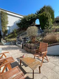 a patio with two wooden chairs and a table at Fuldablick in Melsungen