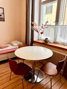 a table and chairs in a room with a window at Downtown Townhouse! in Helsinki +13 photos