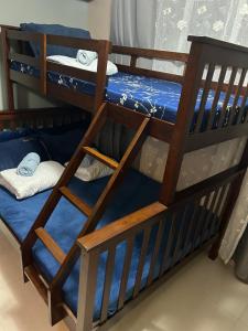 a set of bunk beds with blue sheets and towels at R and RMI CONDOTEL in Baguio +25 photos