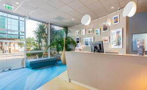 a lobby of a hotel with a reception counter at ibis Styles Toulon Centre Port in Toulon