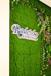 a sign on the side of a green wall at Хотелски комплекс Радецки град Козлодуй in Kozloduy