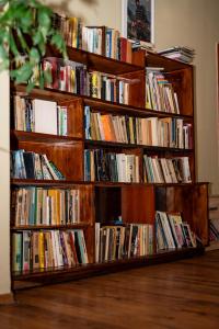 a row of bookshelves filled with books at Хотелски комплекс Радецки град Козлодуй in Kozloduy +24 photos