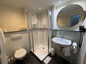 a bathroom with a shower and a toilet and a sink at Hotel gold Self-Check-In-Hotel Pfullendorf in Pfullendorf