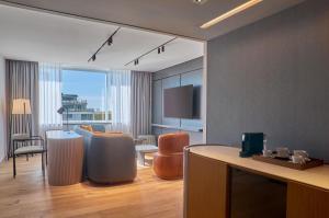 a hotel room with a dining area and a living room at Hilton Buenos Aires in Buenos Aires