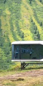 a glass building sitting on top of a hill at Kolsay tany in Kurmenty +4 photos