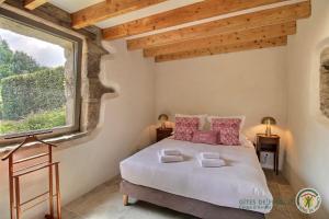 a bedroom with a bed and a large window at Kerguntuil in Pleumeur-Bodou