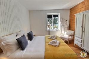 a bedroom with a large bed with towels on it at Villa caroline in Trébeurden