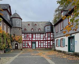 a large red and white building with many windows at Hotel und Restaurant Hohe Schule in Herborn