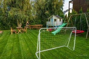a net in a yard with a playground at Domki wczasowe AlexJan in Dąbki