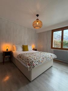 a bedroom with a large bed with two tables and a lamp at Chalet d'Honneur in Chamonix