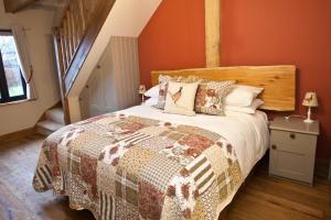 a bedroom with a large bed and a staircase at The Plough Inn in Stalisfield