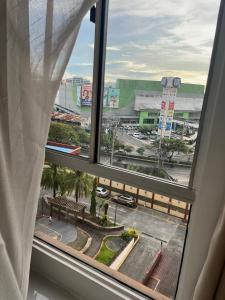 a window with a view of a parking lot at Welcome to lucky7suites in Manila