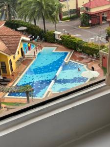 a view of a swimming pool from a window at Welcome to lucky7suites in Manila