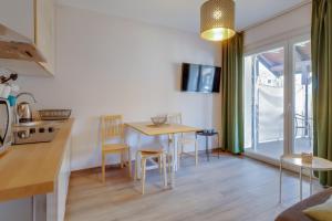 a kitchen and living room with a table and chairs at Move&Rest Slunj in Slunj