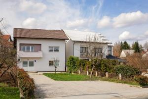 a white house with a fence and a driveway at Move&Rest Slunj in Slunj