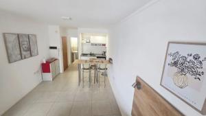 a kitchen with a table and stools in a room at Departamento centro Parana 2 in Paraná
