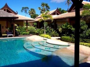 a swimming pool in front of a house at Baan Tropicana in Mae Nam +118 photos
