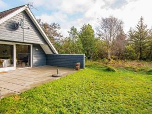 a backyard of a house with a patio at 6 person holiday home in Ringkøbing in Ringkøbing